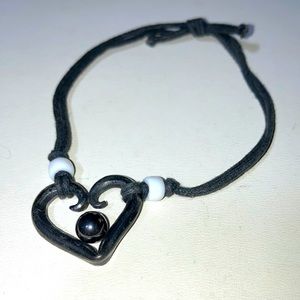 Black twine bracelet w heart and magnetic moveable ball.  Gently used. Bme2732